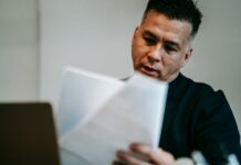 5 Powerful Benefits of Cross-Platform AI Commenting Professional man intently reviewing paperwork at his workstation indoors.